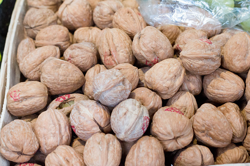 Californian Walnuts in Borough Market, London. There are brand signs visible in the background