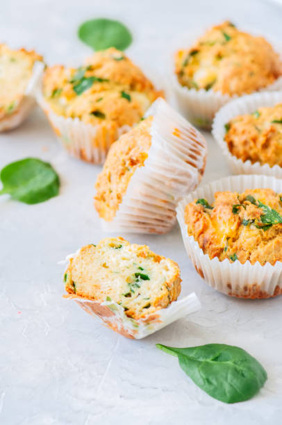 istock Savory potato spinach and feta muffins served on a plate. White stone background. 959487986