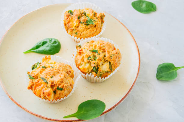 istock Savory potato spinach and feta muffins served on a plate. White stone background. 959487988