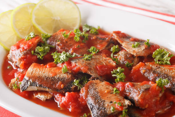 istock sardines in tomato sauce, decorated with lime and parsley macro. Horizontal 959488948