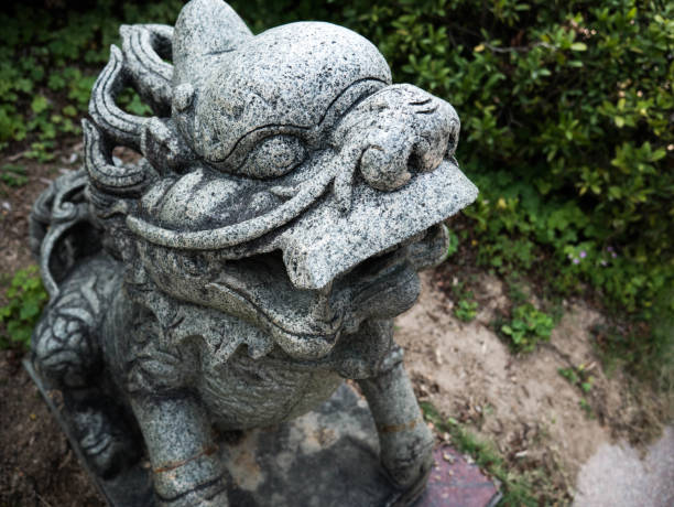 istock Old china lion statue in front of temple 959491496