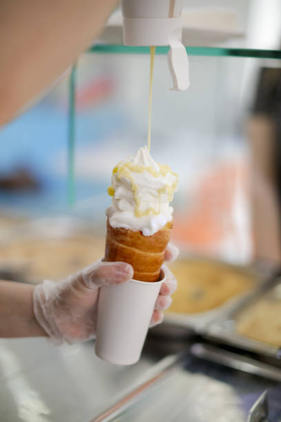 istock Putting dessert topping in soft serve ice cream 959491884