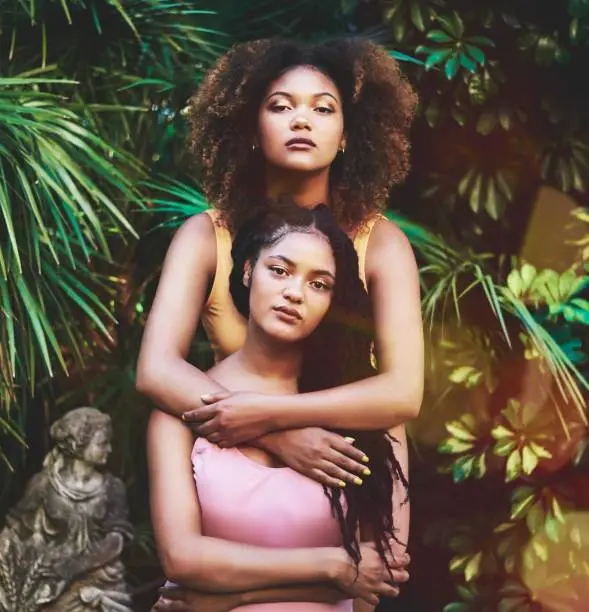 Portrait of two beautiful young women posing in nature