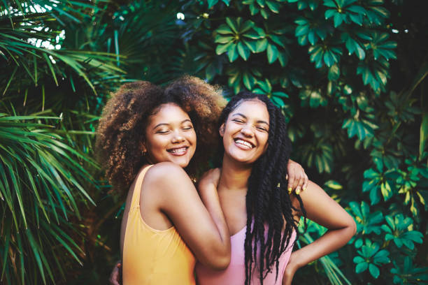 Embracing their natural beauty Cropped shot of two beautiful young women posing in nature black woman hair braids stock pictures, royalty-free photos & images