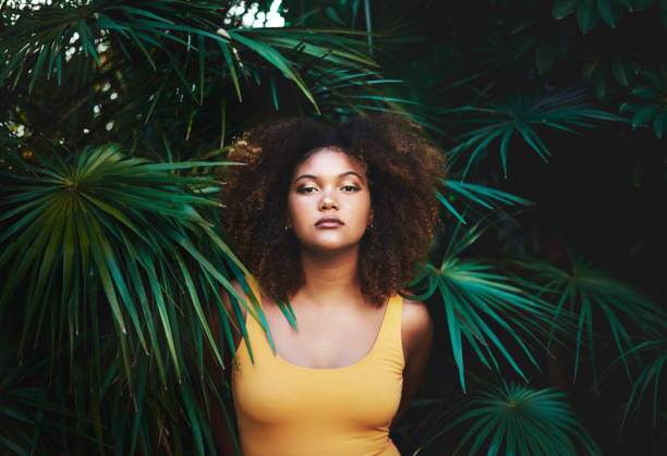 Looking like a modern day mother nature Portrait of a beautiful young woman posing in nature black woman bathing suit stock pictures, royalty-free photos & images