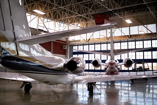 Private jet aircraft in the hangar open for regular maintenance service.
