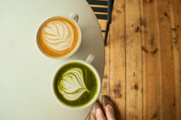 Top view of cup of matcha tea and cappuccino.