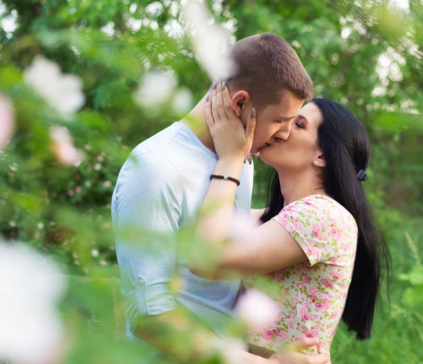 Young couple kissing in the spring nature.