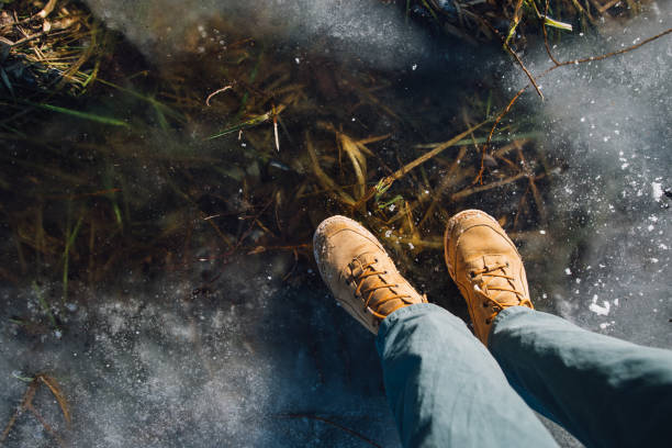 istock man stay on the cracked ice on the lake 959498176