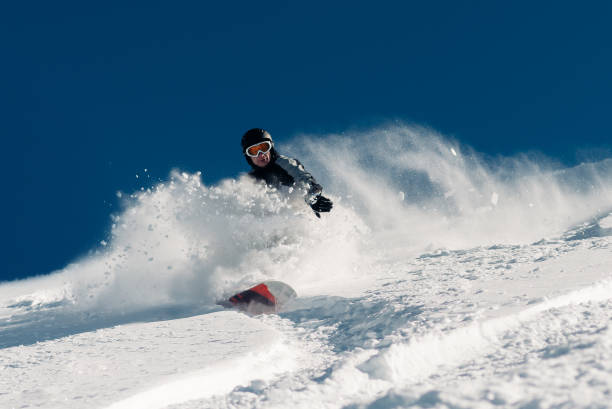 istock snowboarder is riding from snow hill 959498816
