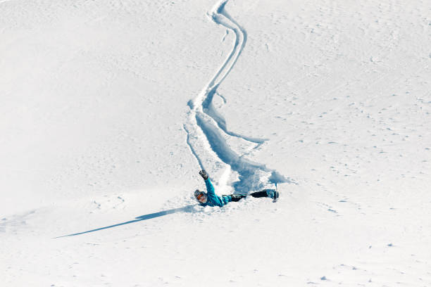 istock Girl is riding from snow hill and fall down 959499074