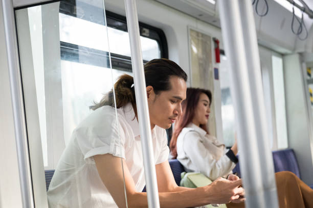 istock Man sits on the train and works on his mobile phone 959502136