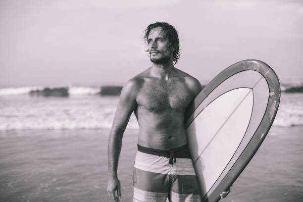 istock Surfer man with surfboard at the beach 959508680