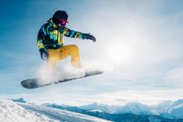 istock snowboarder is jumping in the sun beam 959508720