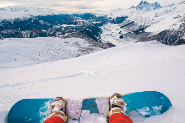 istock snowboarder with snowboard is sitting on the mountain 959508854