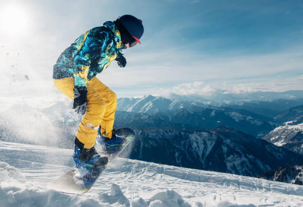 istock snowboarder is jumping in the sun beam 959509138