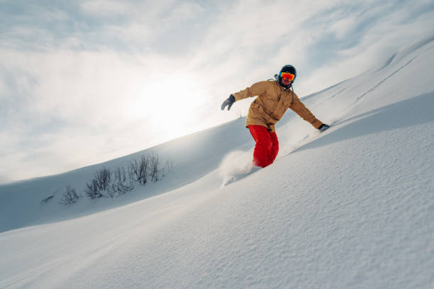 istock snowboarder is riding from snow hill 959509706