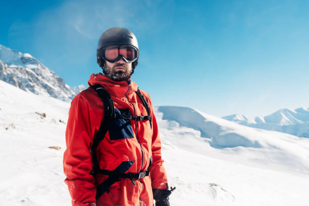 serious snowboarder is standing in the red suit stock photo