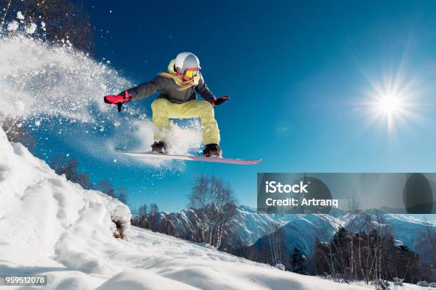 Girl Is Jumping With Snowboard Stock Photo - Download Image Now - Snowboarding, Ski, Snowboard