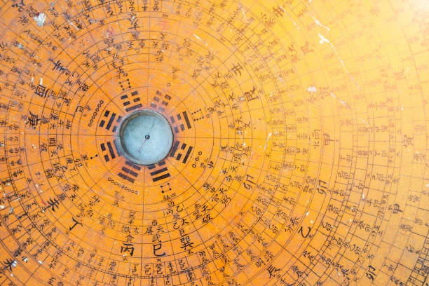 Compass is casting a shadow on a table in the sun