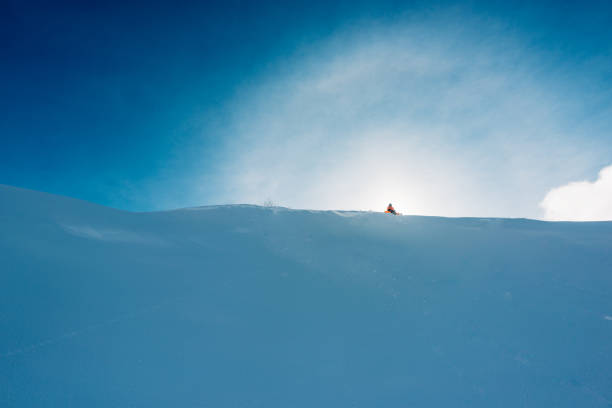 istock snowboarder is sitting on the snow hill 959512602