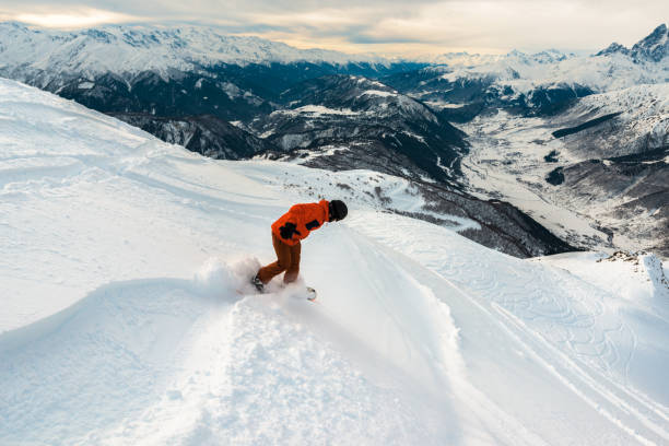 istock snowboarder is riding with snowboard on the mountain 959512982