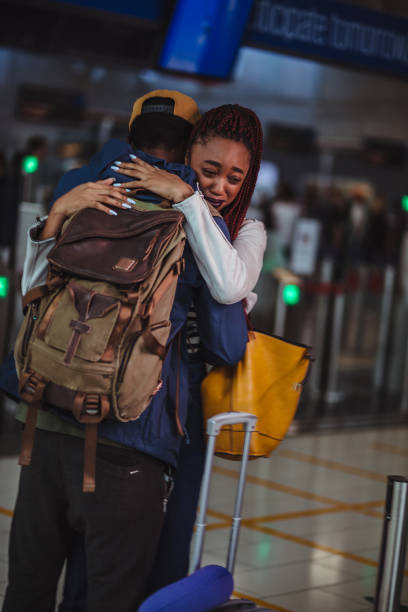istock Young couple embracing at airport before flight departure 959517030