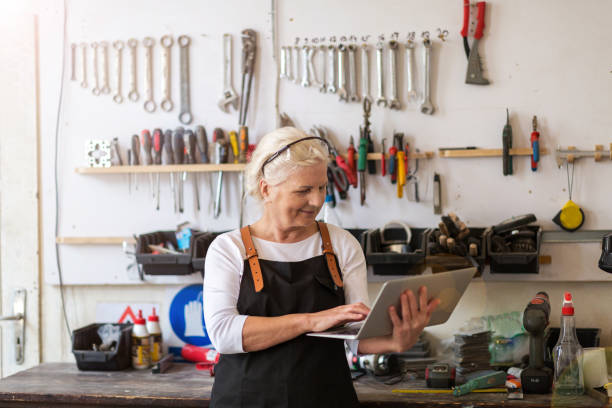 istock Senior woman using a laptop in a workshop 959519862