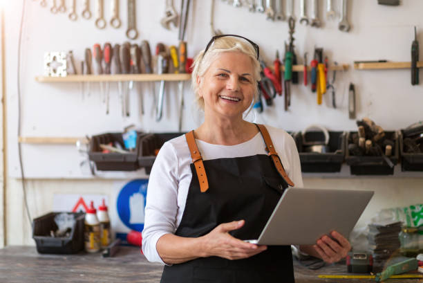 istock Senior woman using a laptop in a workshop 959522080