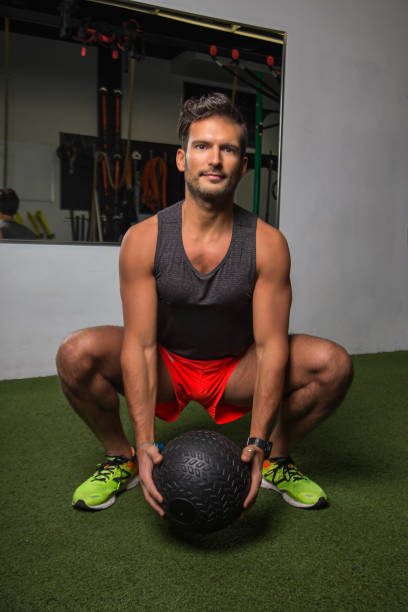 istock Squatting with weighted ball 959527266