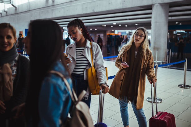 istock Multi-ethnic passengers standing in queue for check-in at airport 959527508