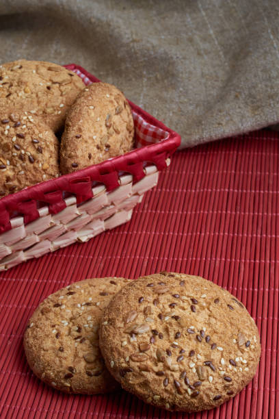 istock Savory cookies sprinkled with sesame seeds, sunflower on table and burlap background 959528718