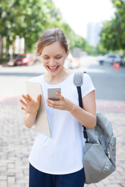 istock Happy female student walking and enjoying mobile message 959531390
