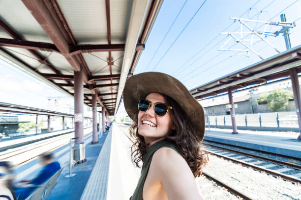 istock Pretty young woman in a train station 959531412