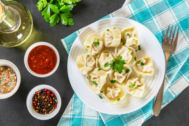 istock Homemade ready dumplings on a gray concrete table. 959537114