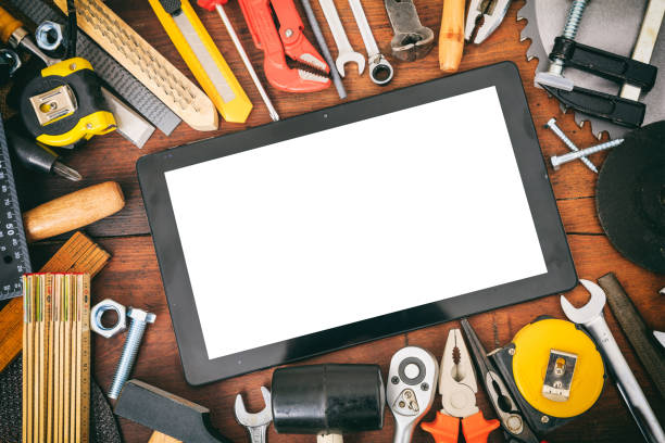 istock Variety of hand tools and tablet on a wooden table 959539252