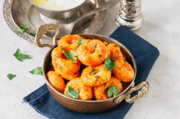 Traditional Turkish food - fellah koftes, polpettes from bulgur and semolina in tomato sauce with parsley and ayran. Middle eastern food concept.