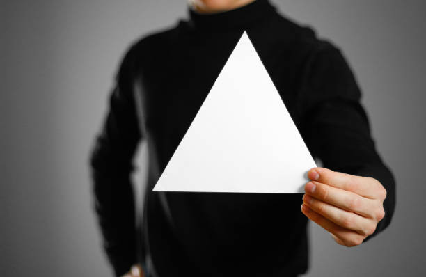 istock Man showing blank triangular white paper. Leaflet presentation. Pamphlet hold hands. Man show clear offset paper. Sheet template 959550998