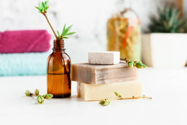 Natural handmade soap for SPA procedures, with oils on a light wooden background