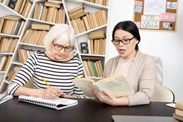 istock Successful tutor conducting lesson to senior woman 959555074