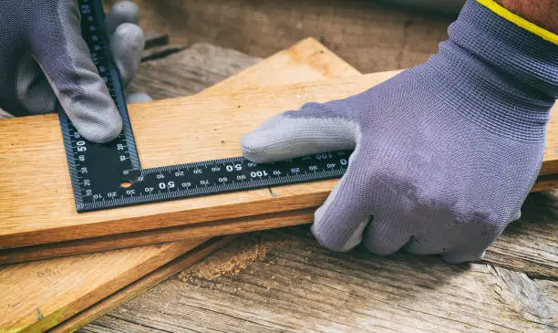 Photo of Carpenter working with a square metal angle