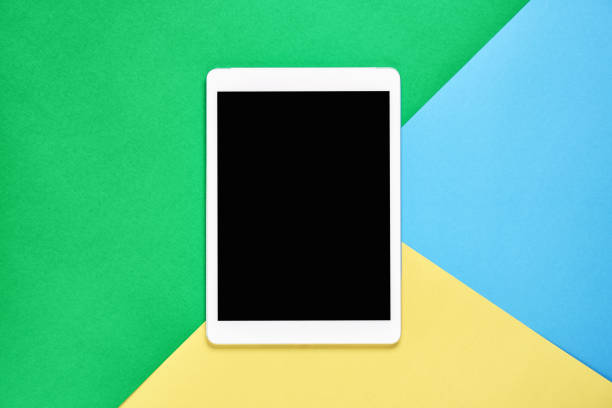 istock Top view; Modern workplace with tablet placed on a pastel yellow background. Copy space suitable for use in graphics. 959560712