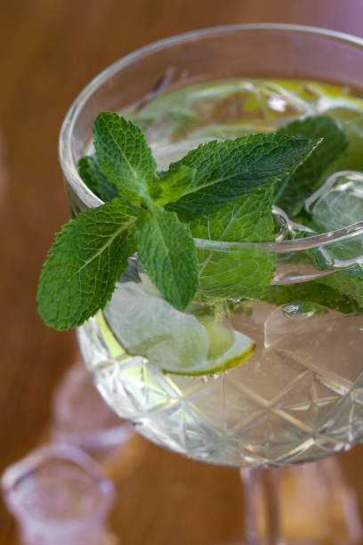 istock Cocktail with vodka, mint and lemon in glass on the bar 959561866