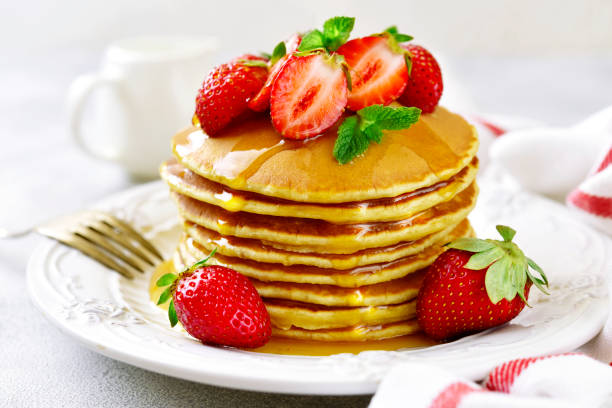 istock Stack of delicious pancakes with maple syrup and fresh strawberry 959564562