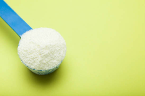 istock Milk powder in a measuring spoon 959567948