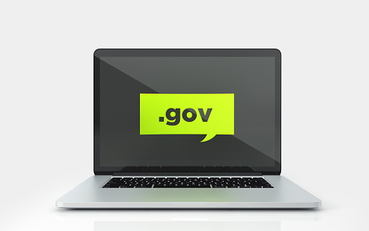 Green speech bubble with gov domain extension on a laptop screen on white background. Horizontal composition with copy space.
