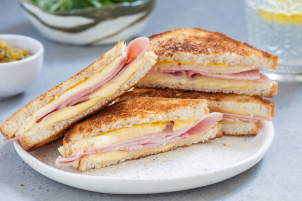 grilled ham and cheese sandwiches grilled ham and cheese sandwiches golden brown ham and cheese sandwich stock pictures, royalty-free photos & images