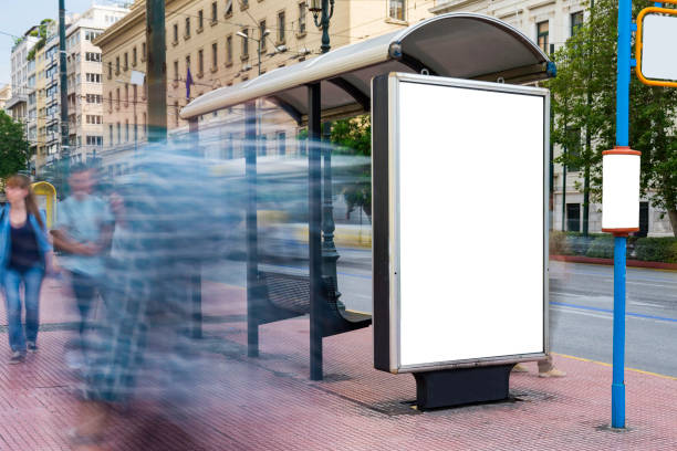 mock up of blank white vertical bus stop in a city with blurred people - bus stop imagens e fotografias de stock