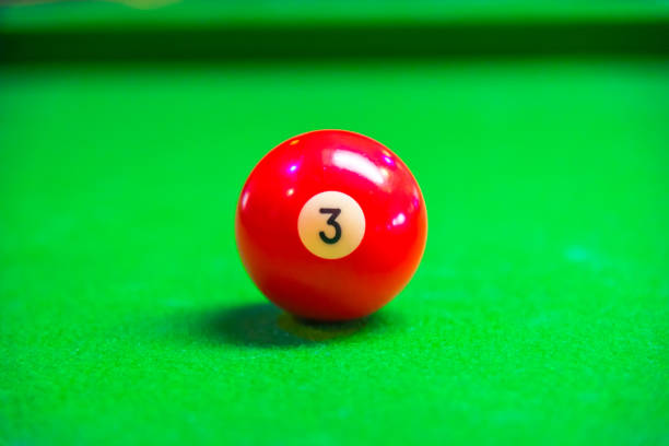 istock Billiard ball in a green pool table focus on red ball 959580172