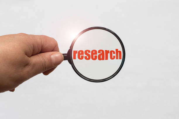 istock Text research and a magnifying glass on white background 959581702